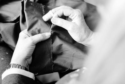 Cropped image of woman sewing on table at home