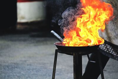 Close-up of fire burning in utensil