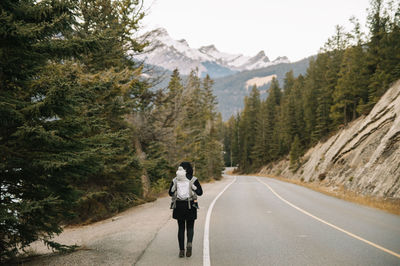 Rear view of man on road against mountain range