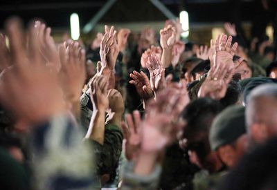 Close-up of people applauding at popular music concert