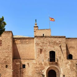Low angle view of building against clear blue sky