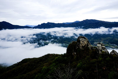 Scenic view of mountains against cloudy sky