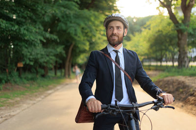 Portrait of young man standing in park