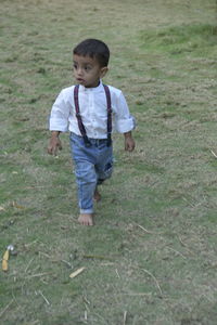 Boy walking on field