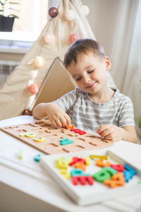 Boy drawing on table