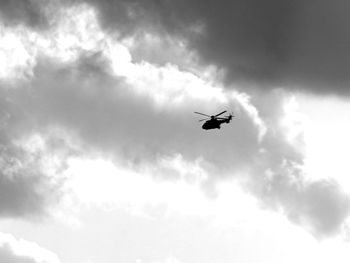 Low angle view of silhouette airplane flying in sky