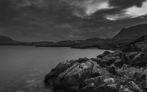 Scenic view of sea and mountains against sky