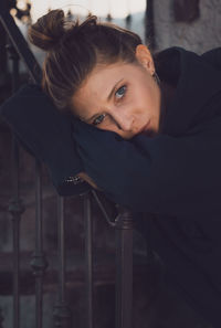 Portrait of young woman sitting on chair