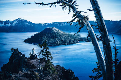 Scenic view of sea and mountains against sky