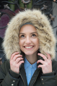 Happy woman wearing jacket and fake fur