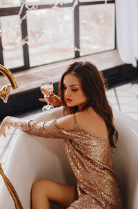 Young woman sitting on table