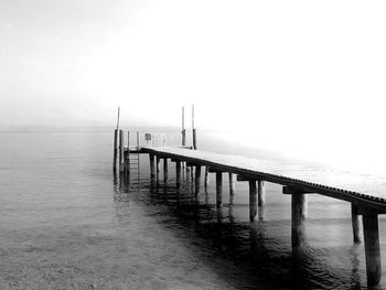 Pier over sea against sky