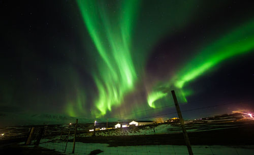 Low angle view of illuminated street lights against sky at night