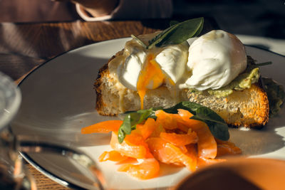 Lunch at the restaurant - bruschetta with poached egg and salted salmon