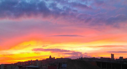 Silhouette buildings against sky during sunset