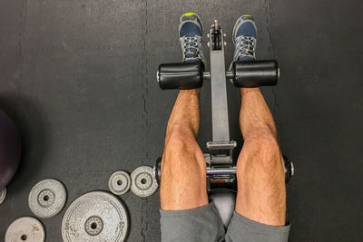 Low section of man doing leg press at gym 