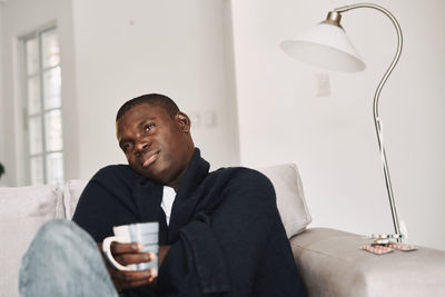 Portrait of man sitting at home