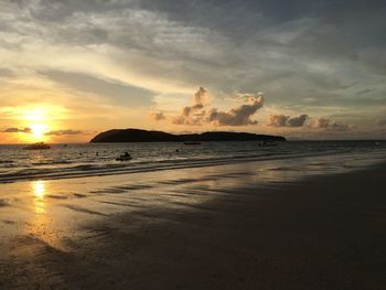 Scenic view of beach against sky during sunset