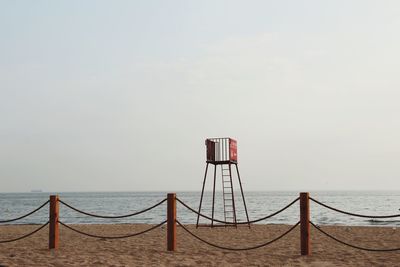 Lifeguard hut on beach against sky