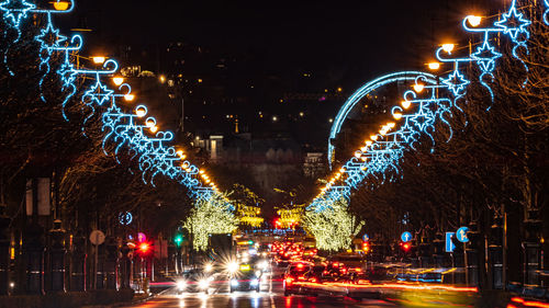 Illuminated light trails on road at night