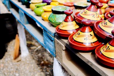 High angle view of multi colored containers in row on table