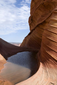 Scenic view of rock formations against cloudy sky,the wave