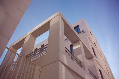 Low angle view of modern building against clear blue sky