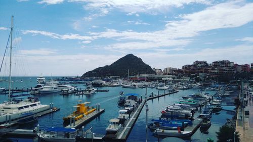 High angle view of boats moored at harbor against sky