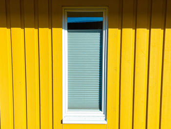 Closed window in yellow building