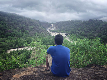 Rear view of man looking at mountains