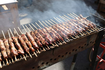 High angle view of meat on barbecue grill