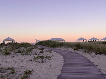 Scenic view of beach against clear sky during sunset