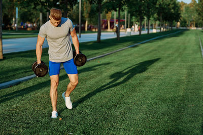 Full length of man with ball on grass