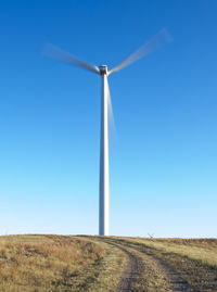 Wind turbines in colorado against blue sky