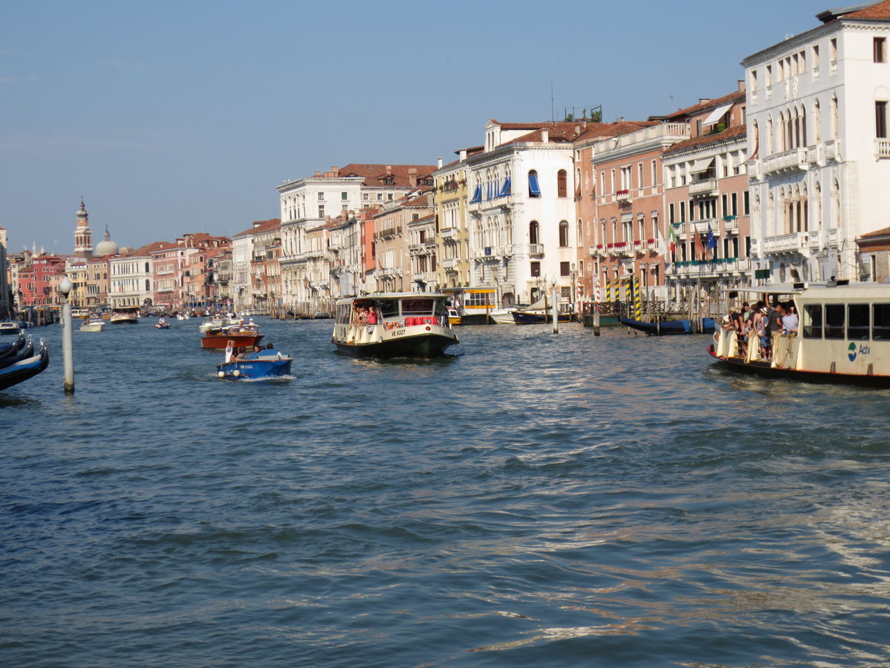 building exterior, architecture, built structure, nautical vessel, water, transportation, waterfront, boat, mode of transport, clear sky, moored, canal, city, rippled, residential building, residential structure, river, travel, sea, building