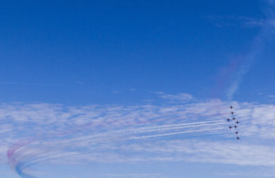 Low angle view of vapor trail against blue sky