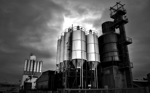 Low angle view of industry against sky