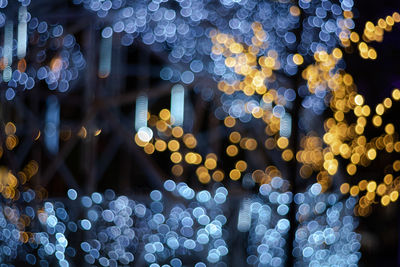 Defocused image of illuminated christmas lights at night