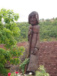 Statue against trees and sky