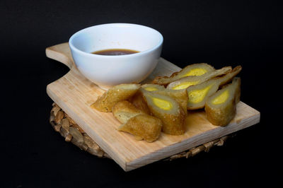 Close-up of coffee beans on table against black background