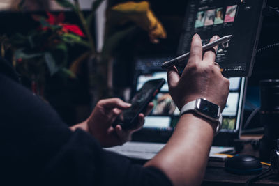 Midsection of man using mobile phone