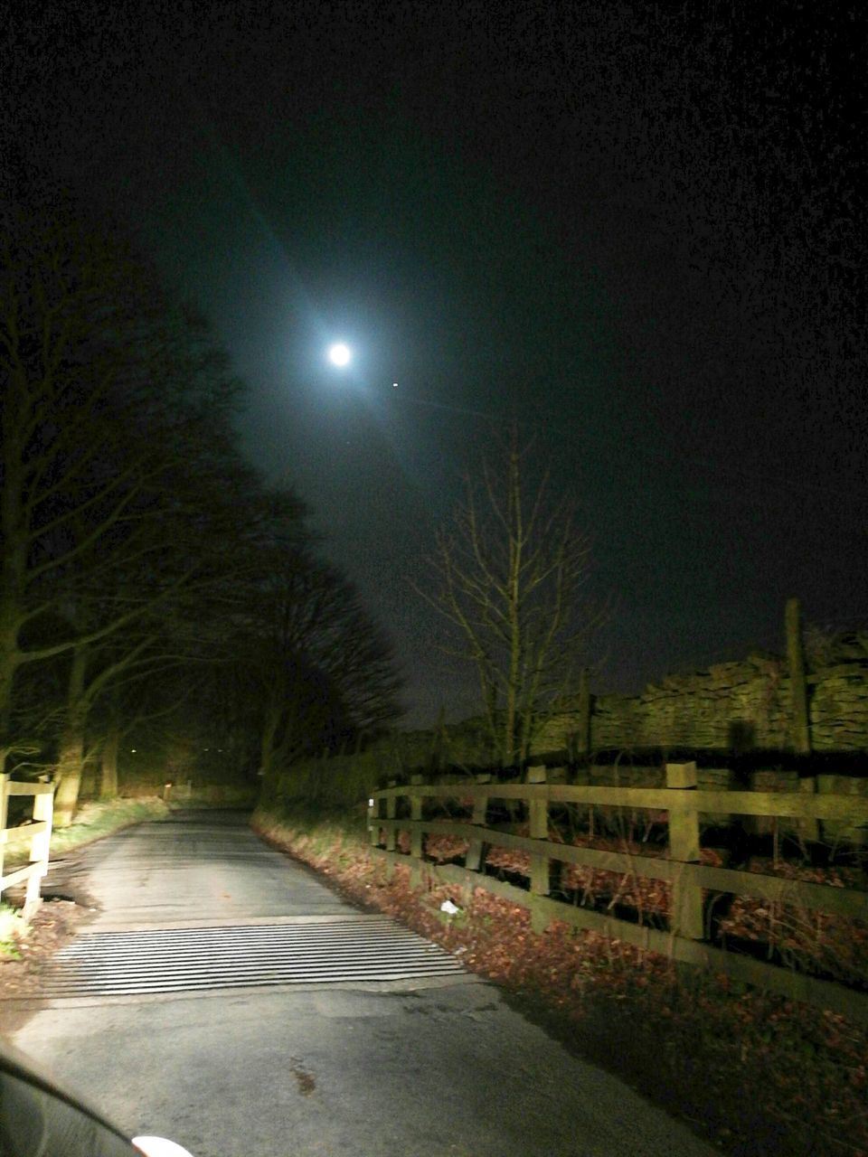 ILLUMINATED STREET LIGHT AGAINST SKY