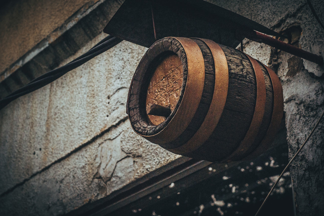 LOW ANGLE VIEW OF OLD RUSTY WINDOW ON WOOD