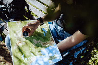 High angle view of hand holding leaves