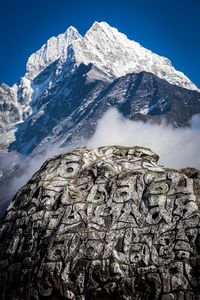 Low angle view of snowcapped mountains against clear sky