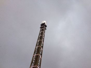 Low angle view of crane against sky