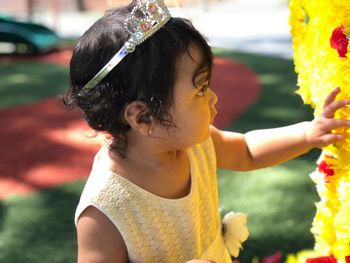 Close-up of girl looking at flowers