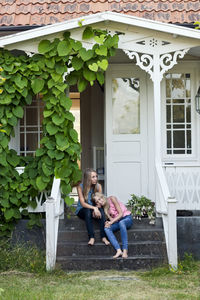 Sisters together in front of house, oland, sweden