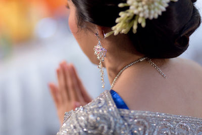 Midsection of woman wearing earring