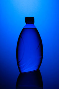 Close-up of water bottle in blue light